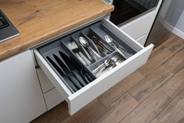 Opened kitchen drawer with Stainless steel cutlery set