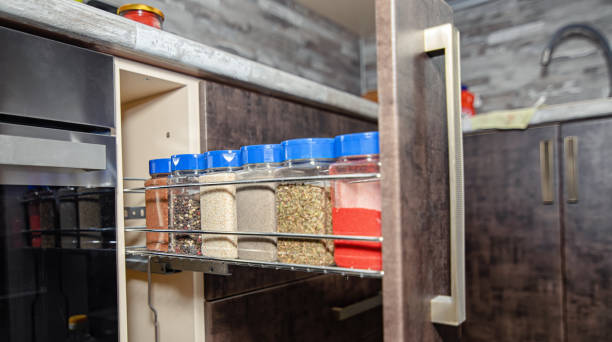 Different spices in separate jars are in a special drawer in the new kitchen