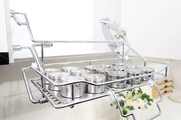 Pull out spice rack in chromed metal with many jars. Kitchen furniture