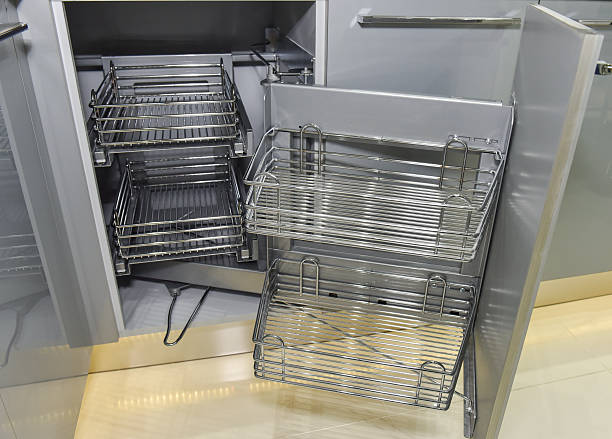 Closeup of space saving corner cupboard in a kitchen with metal shelves