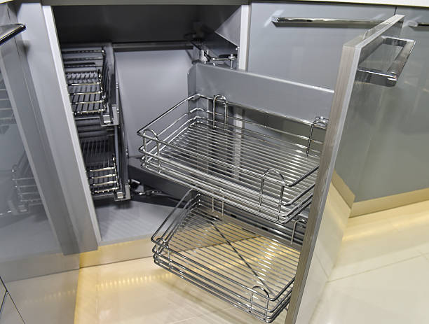 Closeup of space saving corner cupboard in a kitchen with metal shelves