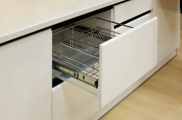 Modern kitchen, storage space for plates, drawer in luxury kitchen.