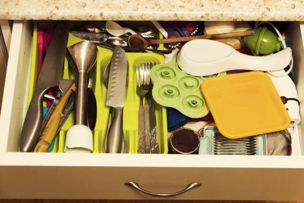 A variety of kitchen utensils in an open kitchen drawer.